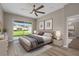 Serene bedroom with a large window overlooking the backyard and a modern ceiling fan at 11045 Belmere Isles Ct, Windermere, FL 34786