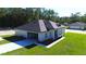 Aerial view of a well-maintained home with a manicured lawn and attached two-car garage at 13356 Sw 64Th Street Rd, Ocala, FL 34482