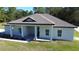 Charming one-story home with a covered porch, simple landscaping and a well-manicured lawn at 13356 Sw 64Th Street Rd, Ocala, FL 34482