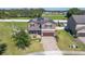 Charming two-story home featuring a brick driveway, solar panels, and well-manicured landscaping at 556 Keyhold Loop, Apopka, FL 32712