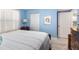 Light blue bedroom with a double bed and built-in closet at 4670 Links Village Dr # B405, Ponce Inlet, FL 32127