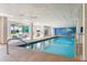 Indoor community pool with seating and large windows at 4670 Links Village Dr # B405, Ponce Inlet, FL 32127