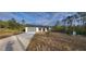 New construction home with driveway and surrounding trees at 1109 East Pkwy, Deland, FL 32724