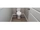 Small bathroom with white toilet and gray walls at 1109 East Pkwy, Deland, FL 32724