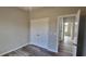 Bedroom with double door closet and wood-look floors at 1109 East Pkwy, Deland, FL 32724