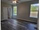 Spacious bedroom with wood-look flooring and large windows at 1109 East Pkwy, Deland, FL 32724