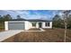 Single-story house with gray garage door and landscaping at 1109 East Pkwy, Deland, FL 32724