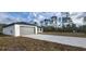 Newly built home with gray garage door and a long concrete driveway at 1109 East Pkwy, Deland, FL 32724