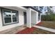 Front entrance with gray door and wood-look tile flooring at 1109 East Pkwy, Deland, FL 32724