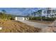 Single story house with gray garage door and gravel driveway at 1109 East Pkwy, Deland, FL 32724