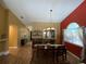 Bright dining room with a large window, hardwood floors, and an adjacent bar area at 2939 Falling Tree Cir, Orlando, FL 32837