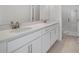 Bathroom featuring double sinks, quartz countertop, and a glass-enclosed shower at 524 Orient Ave, Debary, FL 32713