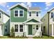 Charming two-story home with green accents, a welcoming front porch, and lush landscaping at 524 Orient Ave, Debary, FL 32713