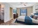 Main bedroom with a large bed, dresser, and ceiling fan at 4621 N Pine Hills Rd # 113, Orlando, FL 32808