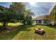 Backyard with a fire pit and a covered patio, ideal for relaxing and entertaining at 10557 Glassborough Dr, Orlando, FL 32825