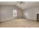 Bedroom featuring neutral carpet, light walls, a window with blinds, and access to the loft at 10557 Glassborough Dr, Orlando, FL 32825