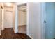 Hallway with hardwood floors leads to bedroom with neutral carpet and white walls at 10557 Glassborough Dr, Orlando, FL 32825