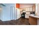 Functional kitchen featuring white cabinets, laminate counters, and standard appliances in a cozy space at 10557 Glassborough Dr, Orlando, FL 32825