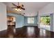 Open living area with sliding glass doors to patio, wood-look floors, and view into adjacent kitchen at 10557 Glassborough Dr, Orlando, FL 32825