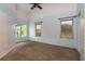 Bright and airy main bedroom with a ceiling fan and multiple windows, offering natural light at 10557 Glassborough Dr, Orlando, FL 32825