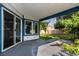 Covered patio with sliding glass door providing seamless indoor-outdoor living at 10557 Glassborough Dr, Orlando, FL 32825