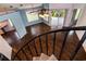 View from spiral staircase overlooking the open living area with wood-look floors and natural light at 10557 Glassborough Dr, Orlando, FL 32825