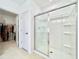 Bright bathroom featuring a walk-in shower with sliding glass doors and adjacent walk-in closet at 1393 Asher Mason Ave, Kissimmee, FL 34744