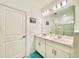 Well-lit bathroom with double vanity, large mirror, and a shower in the background at 1393 Asher Mason Ave, Kissimmee, FL 34744