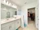 Bright bathroom with double sinks, modern fixtures, and a walk-in shower with glass door at 1393 Asher Mason Ave, Kissimmee, FL 34744