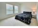 Cozy bedroom with natural light, neutral carpet, and a minimalist design at 1393 Asher Mason Ave, Kissimmee, FL 34744