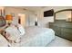 Comfortable bedroom with ensuite access, carpeted floor, matching dresser and a wall mounted TV at 1393 Asher Mason Ave, Kissimmee, FL 34744