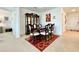 A dining room is shown with matching china cabinet, chairs and table. A red carpet is seen at 1393 Asher Mason Ave, Kissimmee, FL 34744