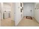 Hallway view featuring tile flooring, wall decor, and convenient access to laundry room at 1393 Asher Mason Ave, Kissimmee, FL 34744