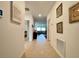Inviting hallway with tile flooring, decorative wall art, and views into the living area at 1393 Asher Mason Ave, Kissimmee, FL 34744