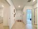 Hallway perspective displaying tile floors, neutral walls with decor, and bedroom access at 1393 Asher Mason Ave, Kissimmee, FL 34744