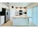 Modern kitchen with stainless steel appliances, white cabinetry, and a center island at 1393 Asher Mason Ave, Kissimmee, FL 34744