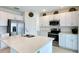Well-lit kitchen featuring stainless steel appliances, white cabinets, and quartz countertops at 1393 Asher Mason Ave, Kissimmee, FL 34744