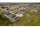 Overhead shot showcasing the neighborhood's layout with similar homes and large green lawns, screened-in patios, and manicured lawns at 246 Kimberly Point Dr, Davenport, FL 33837