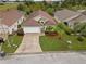 Aerial view of a single-story home with a two-car garage and well-manicured lawn at 246 Kimberly Point Dr, Davenport, FL 33837