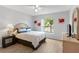 Cozy bedroom with wood-look tile flooring, neutral walls, bright window and queen size bed at 246 Kimberly Point Dr, Davenport, FL 33837