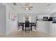 Open dining area with a modern table set, tile flooring, and a view of the kitchen at 246 Kimberly Point Dr, Davenport, FL 33837