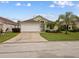 Charming single-story home with a two-car garage and well-manicured lawn at 246 Kimberly Point Dr, Davenport, FL 33837