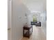 Hallway leading to a spacious living area with tile flooring and natural light at 246 Kimberly Point Dr, Davenport, FL 33837