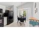 Bright eat-in kitchen area features bay window and modern black appliances at 246 Kimberly Point Dr, Davenport, FL 33837