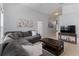 Comfortable living room featuring a large sectional sofa, tile flooring, and neutral wall color at 246 Kimberly Point Dr, Davenport, FL 33837