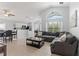 Spacious living room with vaulted ceiling, large windows, and tiled flooring for easy maintenance at 246 Kimberly Point Dr, Davenport, FL 33837