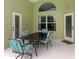 Enclosed patio with seating around glass top table at 246 Kimberly Point Dr, Davenport, FL 33837