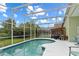 This screened in pool area includes conversational seating and a dining table at 246 Kimberly Point Dr, Davenport, FL 33837
