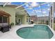 Inviting screened-in pool area with a covered lanai and seating, perfect for relaxation at 246 Kimberly Point Dr, Davenport, FL 33837