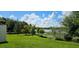 Spacious backyard with a well-manicured lawn and a tranquil lake view, ideal for outdoor relaxation at 593 Lake Wildmere Cv, Longwood, FL 32750